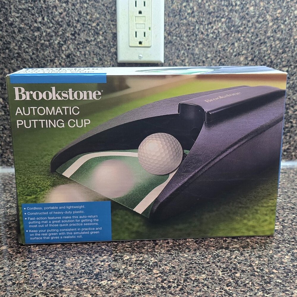 NIP / SEALED Brookstone Automatic Putting Cup Cordless Portable